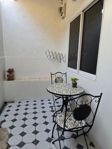 a table and two chairs on a tiled floor at The Old City Rooms in Chiang Mai