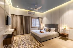 a bedroom with a bed and a ceiling fan at ELIVAAS Shourya Eden Luxe 3BHK Villa with Pvt Pool, Udaipur in Udaipur