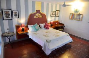 a bedroom with a large bed in a room at Villa Fontainhas in Panaji +13 photos