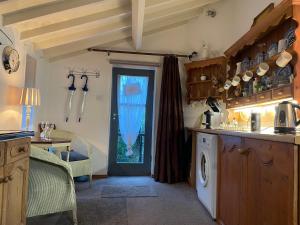 a kitchen with a washer and dryer in a room at The Therapy Rooms Holmfirth Holiday Let in Holmfirth