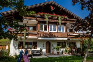 a house with flowers on the front of it at Winkelhof in Oberstdorf