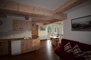 eine Küche mit Holzschränken und einem Tisch im Zimmer in der Unterkunft Winkelhof in Oberstdorf