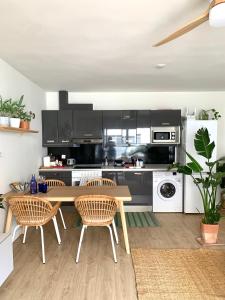 a kitchen with a wooden table and two chairs at Cosy apartment in Almuñecar in Almuñécar