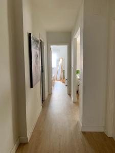 a hallway of an apartment with white walls and wood floors at Cosy apartment in Almuñecar in Almuñécar