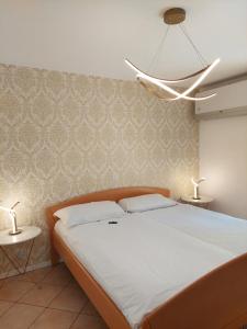 a bedroom with a large bed with two lamps at Dolceresio Lugano Lake B&B in Brusino Arsizio