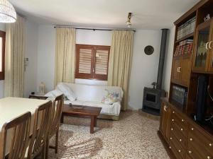 a living room with a couch and a table at Casa los Cactus in Playa Migjorn