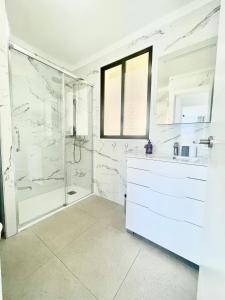 a white bathroom with a shower and a sink at Royal View Apartment - Playa de Las Americas in Playa de las Americas