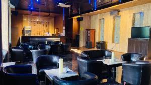 un ristorante con sedie e tavoli neri e un bar di Royal Orchid Central Kireeti-HAMPI Hospet a Hampi