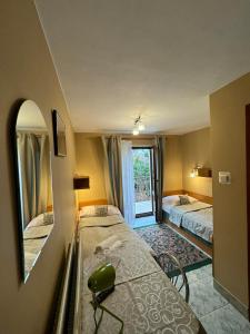 a small room with two beds and a mirror at Galant Hotel in Wieliczka