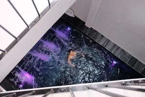 a woman is in the water in a swimming pool at Celia Boutique Hotel in Phong Nha