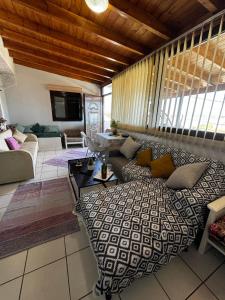 a living room with a couch and a tv at xara house in (( Filaréton ))