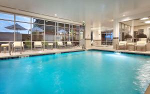 a large swimming pool with blue water in a building at Hilton Garden Inn Boise Downtown in Boise