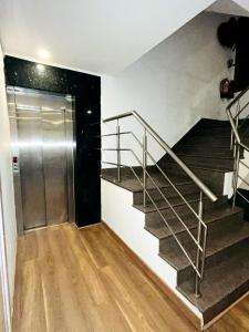 a staircase with a metal railing in a room at Hotel Majestic stay - East of Kailash in New Delhi