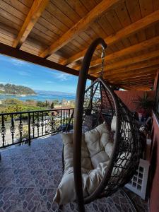 a hammock on a porch with a view of the ocean at xara house in (( Filaréton ))