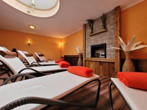 a row of chairs in a waiting room with a fireplace at Pension Zur alten Mühle in Sölden