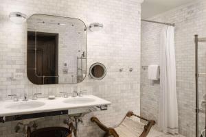 a bathroom with a sink and a mirror at The Beekman, A Thompson Hotel, by Hyatt in New York