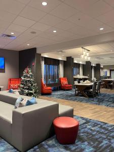 a living room with a christmas tree and a couch at Hampton Inn West Wichita Goddard in Goddard