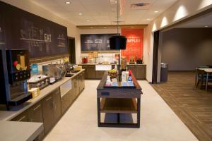 a large kitchen with a counter in a restaurant at Hampton Inn West Wichita Goddard in Goddard