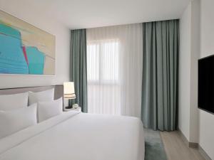 Postel nebo postele na pokoji v ubytování Mövenpick Hotel & Apartments Ghala Muscat