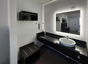 a bathroom with a sink and a mirror at Motel 6 Fort Worth, TX East in Fort Worth