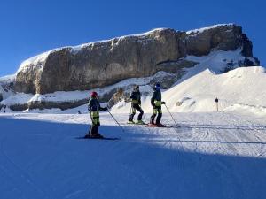 three people on skis in the snow near a mountain at Winkelhof in Oberstdorf