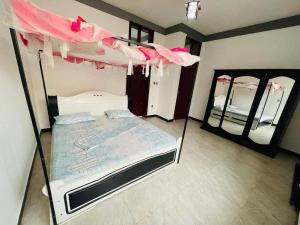 a bedroom with two bunk beds and two mirrors at Eddy's in Mutumba