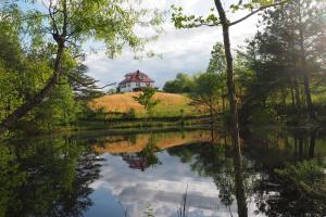 a house sitting on top of a hill next to a lake at Firefly Hills in Beattyville