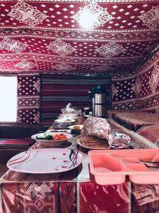 a table with plates of food on top at wadi rum traditional camp in Wadi Rum