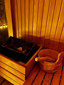a sauna with a hot tub and a wooden toilet at PRIVADO HOTELS in Antalya