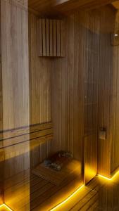 a sauna with a bench in a wooden room with lights at PRIVADO HOTELS in Antalya