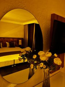 a bedroom with a large mirror and a vase of flowers at PRIVADO HOTELS in Antalya
