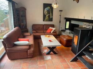 sala de estar con sofá y mesa en Gezellige Chalet met groot zonneterras in Domaine du Bonsoy - vernieuwd in 2024, en Blaimont