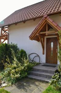 ein Haus mit einer Holztür und einer Treppe in der Unterkunft Agroturystyka w Świcie in Tuchola