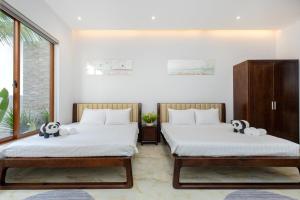 Giường trong phòng chung tại OSAKA HOMESTAY - Villa Hồ Bơi Mới - 5 Phòng Gần Biển