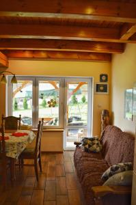 a living room with a couch and a table and window at Agroturystyka w Świcie in Tuchola