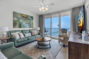 a living room with a couch and a table at Summerwind Center 1304 in Navarre