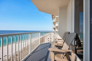 a balcony with a bench and the beach at Summerwind Center 1304 in Navarre