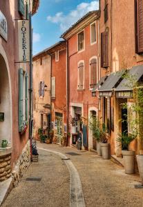an empty street in an old town with buildings at Appartement Roussillon in Roussillon