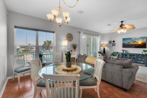 a living room with a table and chairs and a couch at Bonita Bay in Pensacola Beach