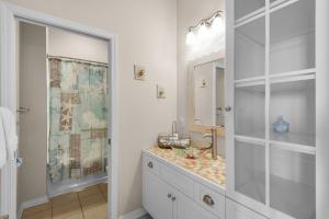 a bathroom with a sink and a mirror at Bonita Bay in Pensacola Beach +54 photos