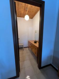 un pasillo con una habitación con una mesa y un espejo en Rooms Pineta, en Verona