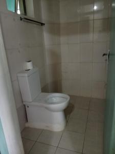 a bathroom with a toilet with a roll of toilet paper at Tamara Studio Apartment in Shanzu in Mtwapa