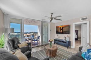 a living room with a couch and a table at Dolphin Point #602A in Destin