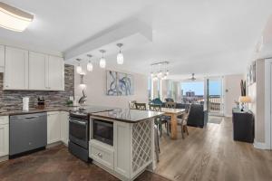 an open kitchen and dining room with a dining table at Dolphin Point #602A in Destin