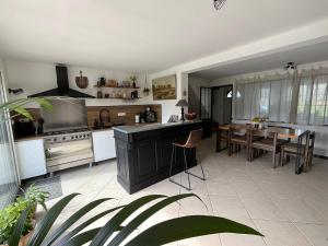 a kitchen with a table and a dining room at La Villa Saint Val in Saint-Valéry-sur-Somme