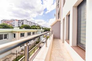 an apartment balcony with a view of buildings at Summer Vibes Apartment in Burgas