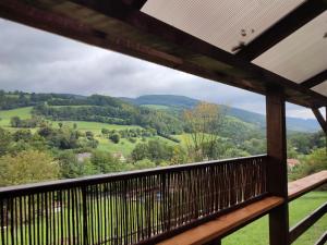 a view from the balcony of a cabin with a view of the mountains at Stodola Svatý Štěpán in Bylnice