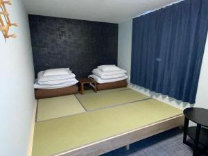 Postel nebo postele na pokoji v ubytování GuestHouse Guu