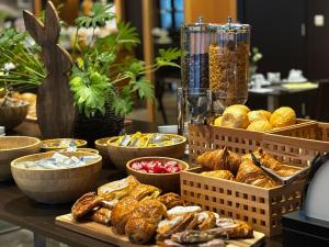 a table with baskets of bread and other pastries at Liberty in Blankenberge