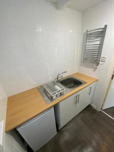 a small kitchen with a sink and a counter at Farina No1, Sea view studio sleeping 2 guests in Bridlington